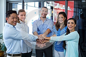 Team of businesspeople forming handstack