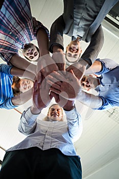 Team of businesspeople forming handstack