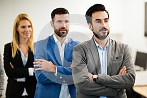 Team of cheerful businesspeople posing for group picture