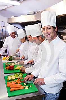 Team of chefs chopping vegetables