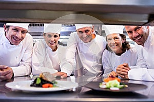 Team of chefs smiling at camera