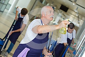 Team cleaners at work in office building