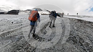 A team of climbers ascending an icy slope on Mt. Everest across the sky above. Clip. People enjoying climbing a snowy