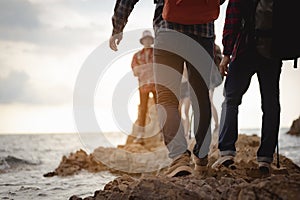 Team of climbers man and woman hiker hiking mountain climbing success stand at the cliff with backpacks on mountain top over.