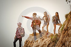 Team of climbers man and woman hiker holding hands to help each other up the hill with red flags for hiking for mountain climbing