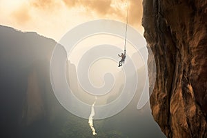 A team of climbers at the top of a high mountain in the light of the setting sun.