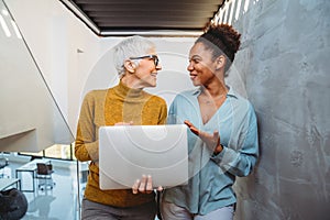 Team collaboration and digital transformation with colleagues sharing ideas at a laptop in office