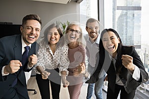 Team of colleagues and older leader woman screaming for joy