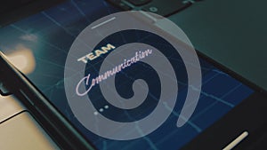 Team communication inscription on mobile phone screen. Communication and business concept. Analog effect