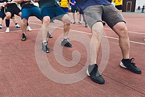 Team competing in tug of war men pull the rope.