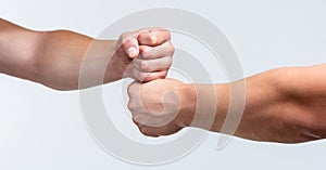 Team concept. People bumping their fists together, arms. Friendly handshake, friends greeting. Two hands, isolated arm