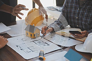 A team of construction engineers talks to managers and construction workers at the construction site. Quality inspection, work