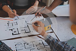 A team of construction engineers talks to managers and construction workers at the construction site. Quality inspection, work