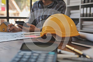 A team of construction engineers talks to managers and construction workers at the construction site. Quality inspection, work