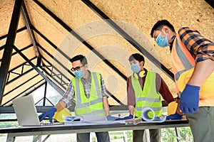 Team of construction engineers and three architects are ready to wear medical masks. Coronavirus or Covid-19 wear masks during the