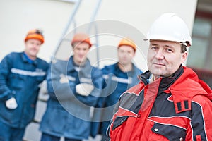 Team of construction workers technicians with foreman in front photo