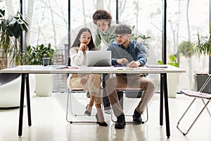 Team Of Coworkers Looking At Laptop Having Issue In Office