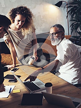 Team of coworkers making great work discussion in modern office.Young business teamwork concept.Bearded man talking with