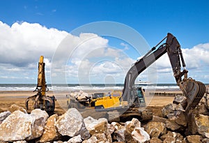 crane or excavator equipped with a grapple handling large rocks