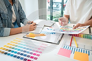 Team of creative graphic designer working on color swatch samples chart for selection coloring in inspiration to create new
