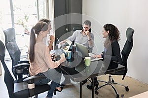 Team of creatives having meeting in agency office photo