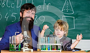Team of creators. bearded man teacher with little boy. father and son at school. Chemistry and physics biology. Back to