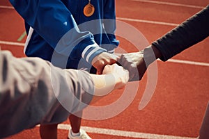 The team that dared to dream. a team of athletes giving each other fist bumps.