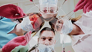 Team of dentists with medical instruments looking at the camera closeup.