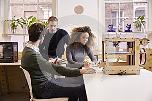 Team Of Designers Working With 3D Printer In Design Studio