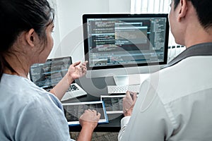 Team of Developer programmer working on coding program software computer in office, Writing website and development database