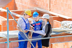 Team discussing construction or building site plans