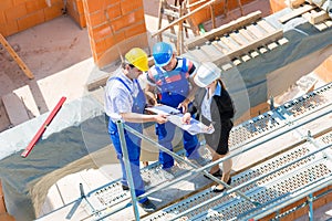 Team discussing construction or building site plans