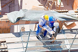 Team discussing construction or building site plans