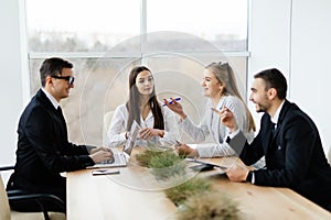 Team discussing at meeting in conference room.