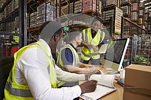 Team discussing warehouse logistics in an on-site office