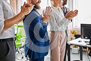 Team of diverse employees applauding, clapping hands, cheering mentor coach