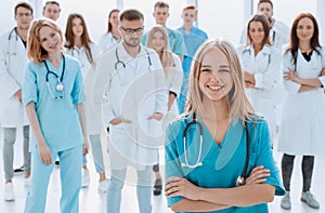 team of diverse medical professionals applauds together.