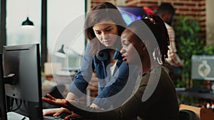 Team of diverse office employees working on multi monitors