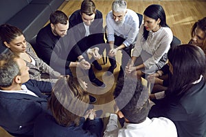 Team of diverse people having a meeting in the office, sitting in a circle and talking
