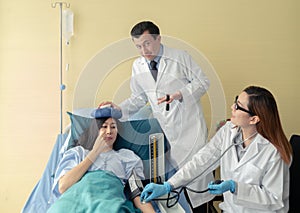 Team of doctor examining a female patient