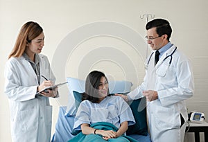 Team of doctor examining a female patient