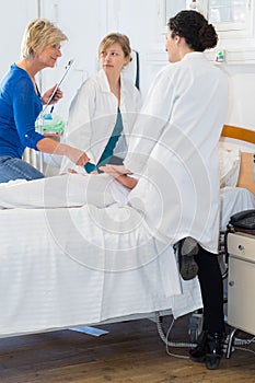 team doctor and nurses examining patient in hospital