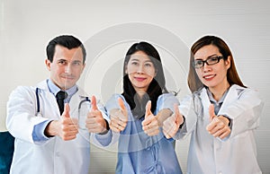 Team of doctor and patient giving thump up