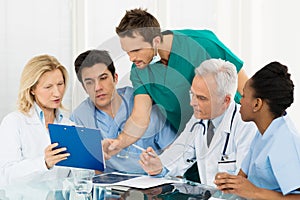 Team Of Doctors Examining Reports