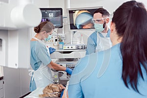 Team of doctors in hospital at endoscopy examining pictures