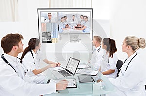 Team of doctors looking at projector screen