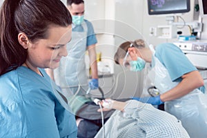 Team of doctors and nurses performing colonoscopy