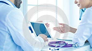 Team of doctors sitting at table in clinic