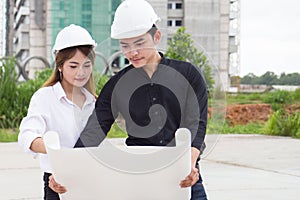 Team of engineer building construction working together. Engineer checking progress of construction.