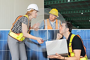Team of engineers and architects working on a solar panel